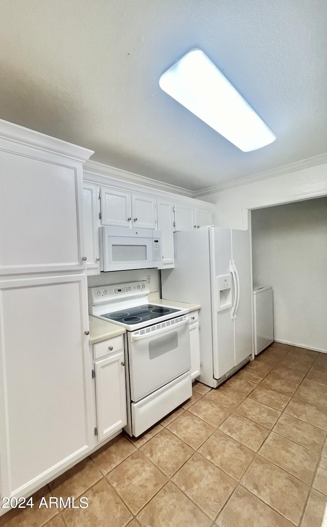 kitchen with crown molding, light tile patterned floors, white cabinets, and white appliances