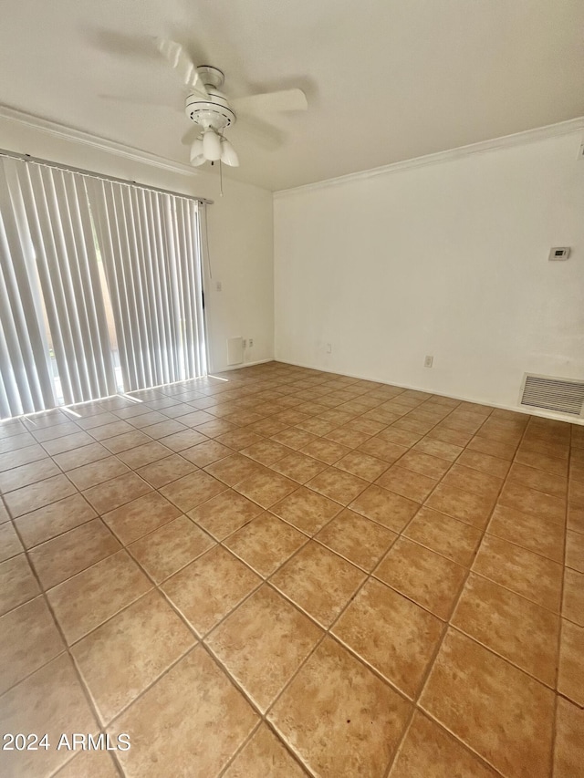 tiled empty room featuring crown molding and ceiling fan