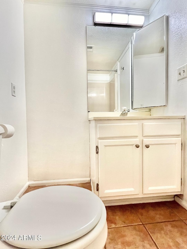 bathroom with vanity, toilet, and tile patterned flooring