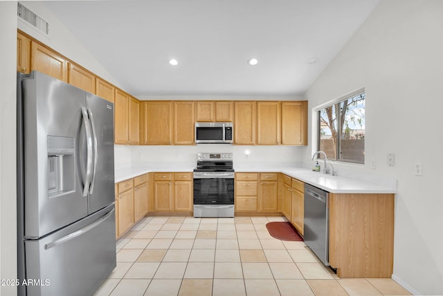 10304 E Plata Ave, Mesa, AZ 85212 - kitchen with appliances with stainless steel finishes, light brown cabinetry, light countertops, lofted ceiling, and recessed lighting