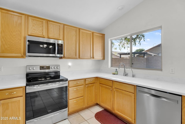 10304 E Plata Ave, Mesa, AZ 85212 - kitchen with appliances with stainless steel finishes, lofted ceiling, light brown cabinets, light tile patterned floors, and light countertops