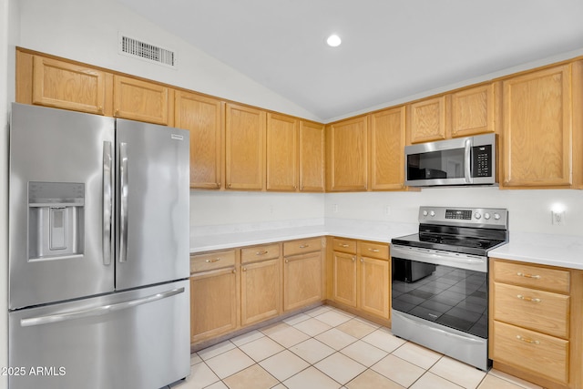 10304 E Plata Ave, Mesa, AZ 85212 - kitchen featuring stainless steel appliances, vaulted ceiling, light countertops, light tile patterned floors, and recessed lighting