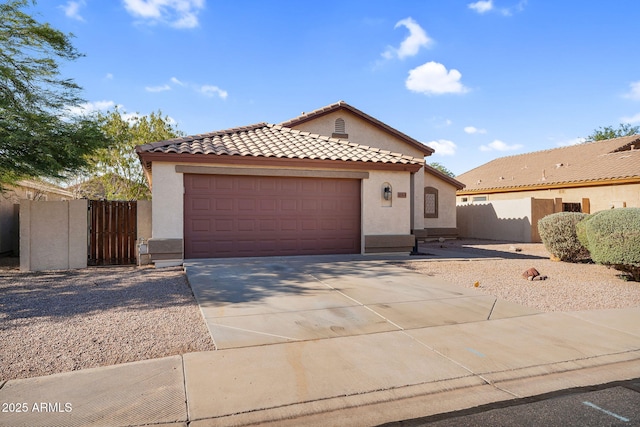 10304 E Plata Ave, Mesa, AZ 85212 - mediterranean / spanish home featuring stucco siding, concrete driveway, a tiled roof, and an attached garage