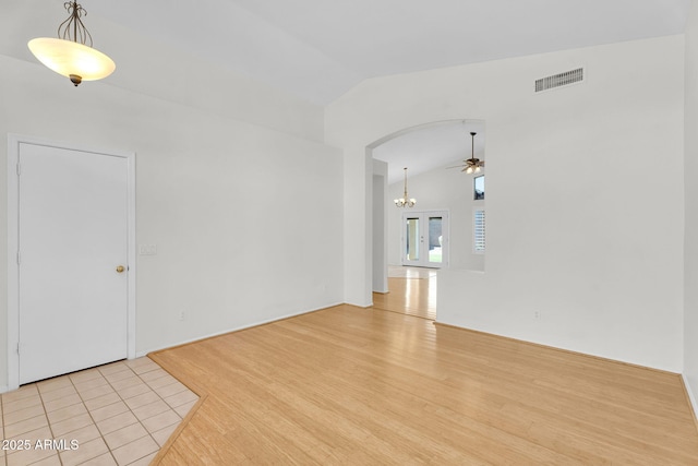 10304 E Plata Ave, Mesa, AZ 85212 - spare room with lofted ceiling, ceiling fan, arched walkways, and light wood-style floors