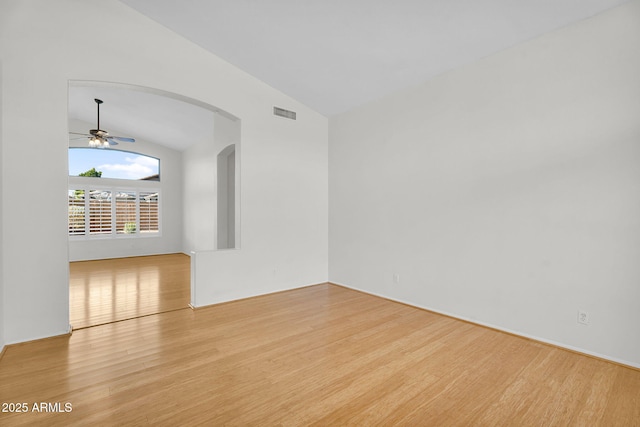 10304 E Plata Ave, Mesa, AZ 85212 - empty room with lofted ceiling, wood finished floors, arched walkways, and ceiling fan