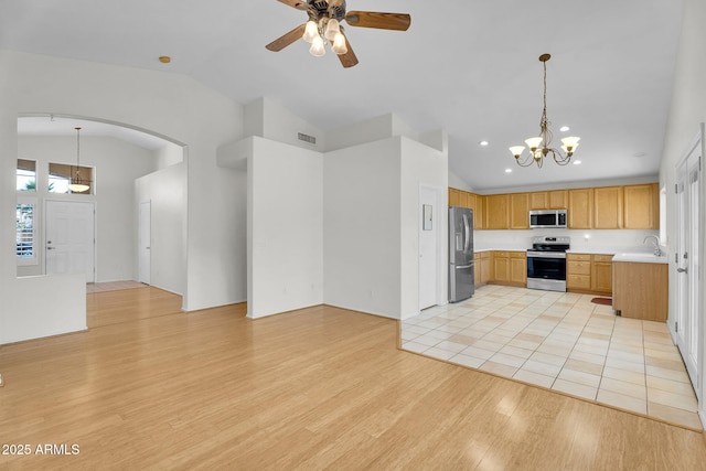 10304 E Plata Ave, Mesa, AZ 85212 - kitchen with appliances with stainless steel finishes, lofted ceiling, a chandelier, light wood-style floors, and light countertops