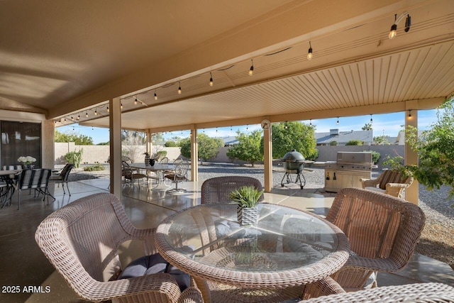 view of patio featuring fence, outdoor dining space, and area for grilling