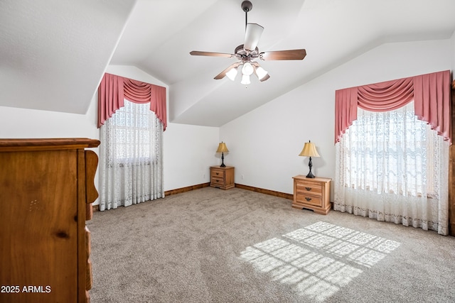 unfurnished bedroom with vaulted ceiling, ceiling fan, and carpet flooring