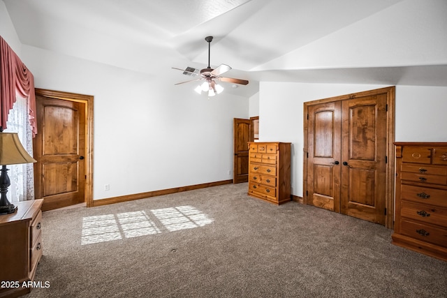 unfurnished bedroom featuring ceiling fan, lofted ceiling, and light colored carpet