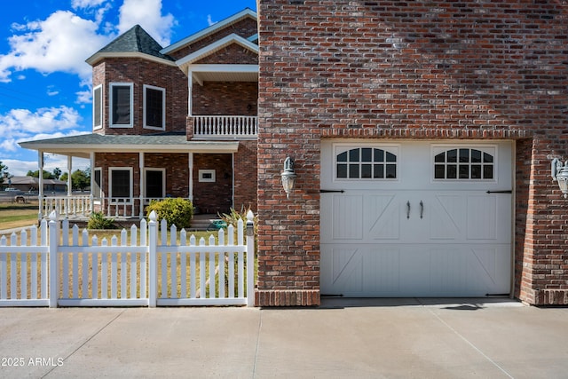 view of front of house featuring a garage and a porch