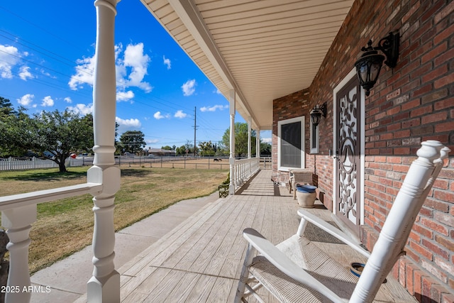 deck featuring a yard and a porch