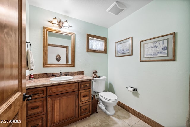 bathroom featuring toilet, vanity, and tile patterned flooring