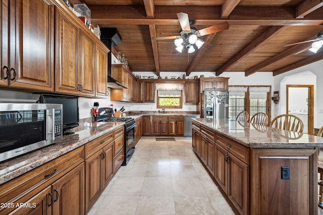 kitchen with wood ceiling, a breakfast bar area, stainless steel appliances, a kitchen island, and beam ceiling