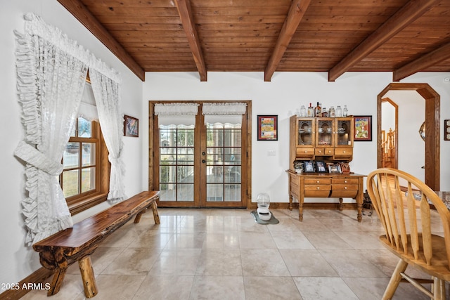 sitting room with vaulted ceiling with beams, french doors, and wood ceiling