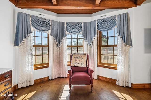 sitting room with a wealth of natural light and dark hardwood / wood-style floors