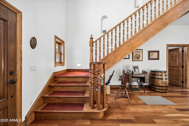 stairway with hardwood / wood-style floors