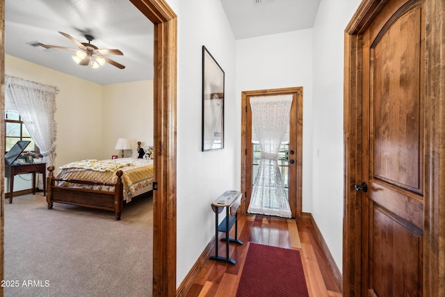 bedroom with ceiling fan and dark hardwood / wood-style floors