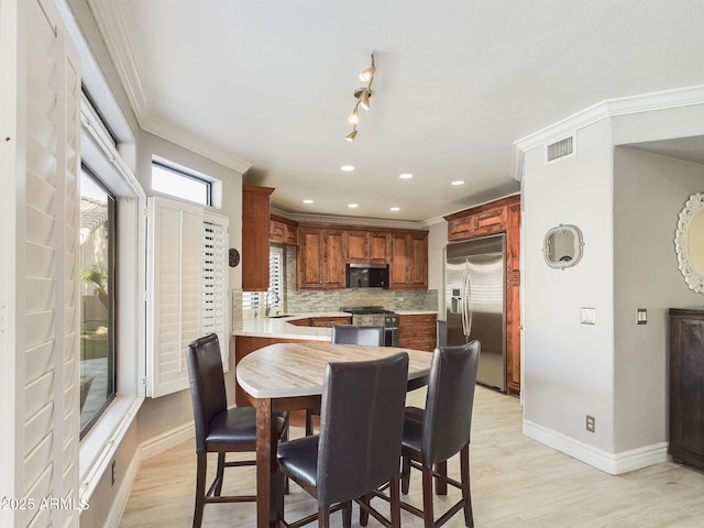 4530 W Misty Willow Ln, Glendale, AZ 85310 - dining space featuring light hardwood / wood-style floors, crown molding, and sink