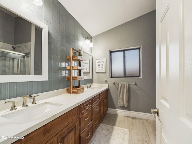 4530 W Misty Willow Ln, Glendale, AZ 85310 - bathroom featuring hardwood / wood-style flooring, vanity, walk in shower, and vaulted ceiling