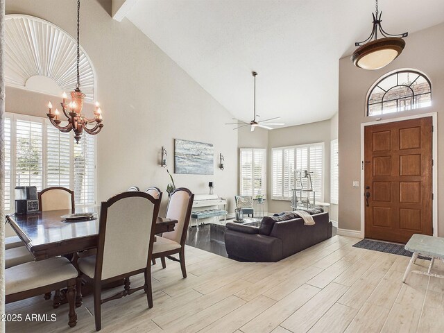 4530 W Misty Willow Ln, Glendale, AZ 85310 - dining area with ceiling fan with notable chandelier, a wealth of natural light, and high vaulted ceiling