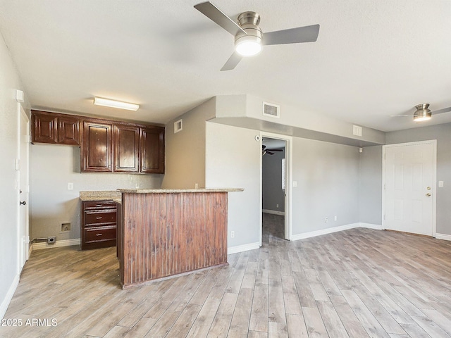 4530 W Misty Willow Ln, Glendale, AZ 85310 - kitchen with dark brown cabinetry and light hardwood / wood-style floors