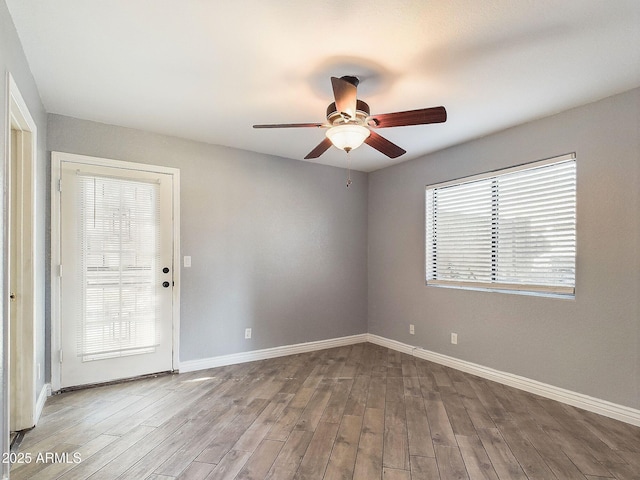 4530 W Misty Willow Ln, Glendale, AZ 85310 - unfurnished room with ceiling fan, hardwood / wood-style floors, and a healthy amount of sunlight
