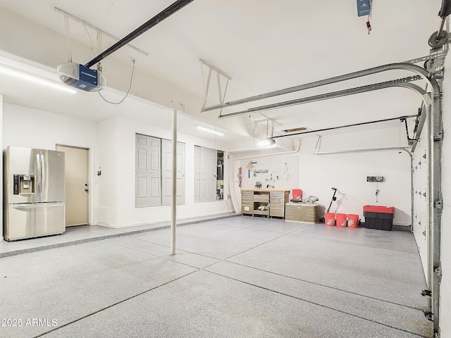 4530 W Misty Willow Ln, Glendale, AZ 85310 - garage featuring stainless steel fridge with ice dispenser and a garage door opener