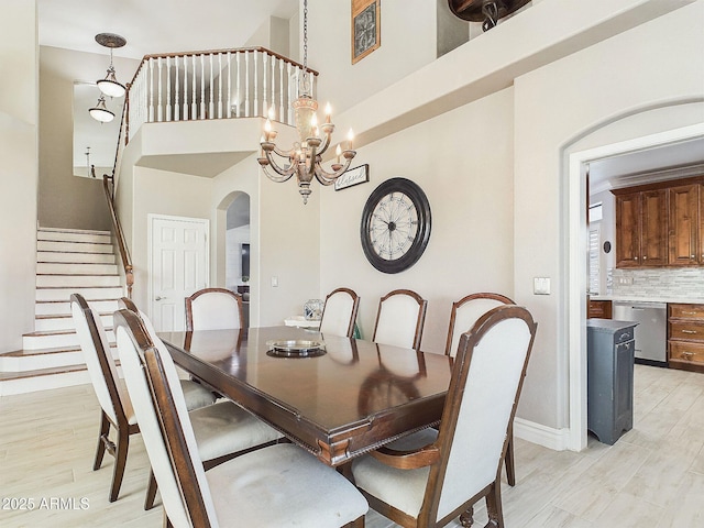 4530 W Misty Willow Ln, Glendale, AZ 85310 - dining room featuring a towering ceiling, a chandelier, and light hardwood / wood-style floors