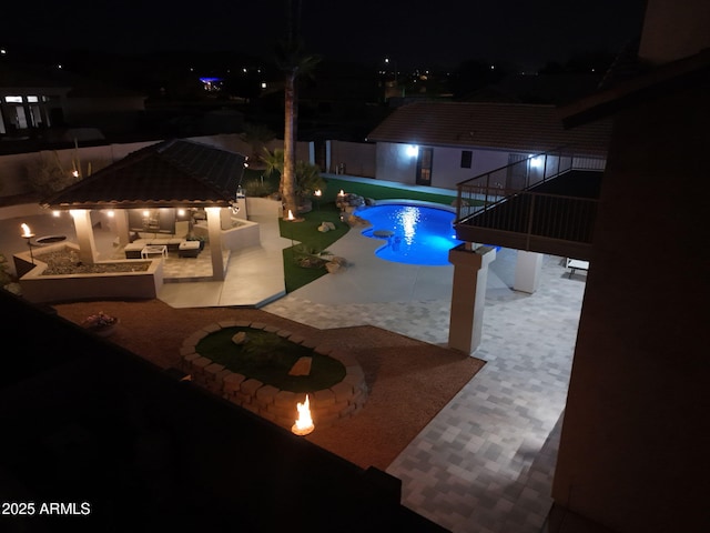 4530 W Misty Willow Ln, Glendale, AZ 85310 - pool at night featuring outdoor lounge area and a patio