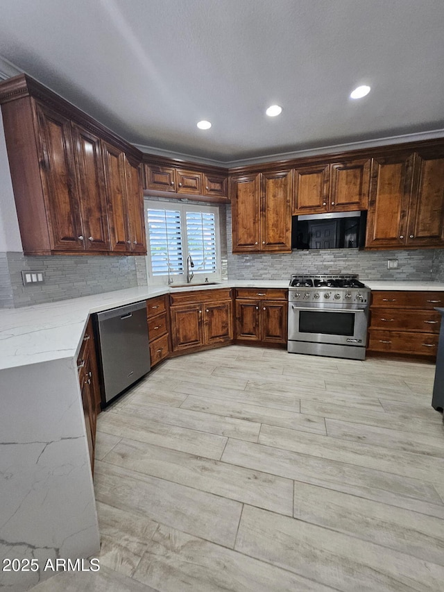 4530 W Misty Willow Ln, Glendale, AZ 85310 - kitchen with sink, light hardwood / wood-style flooring, backsplash, appliances with stainless steel finishes, and ornamental molding