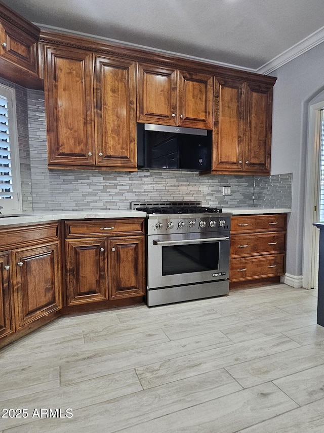 4530 W Misty Willow Ln, Glendale, AZ 85310 - kitchen featuring decorative backsplash, high end range, and crown molding