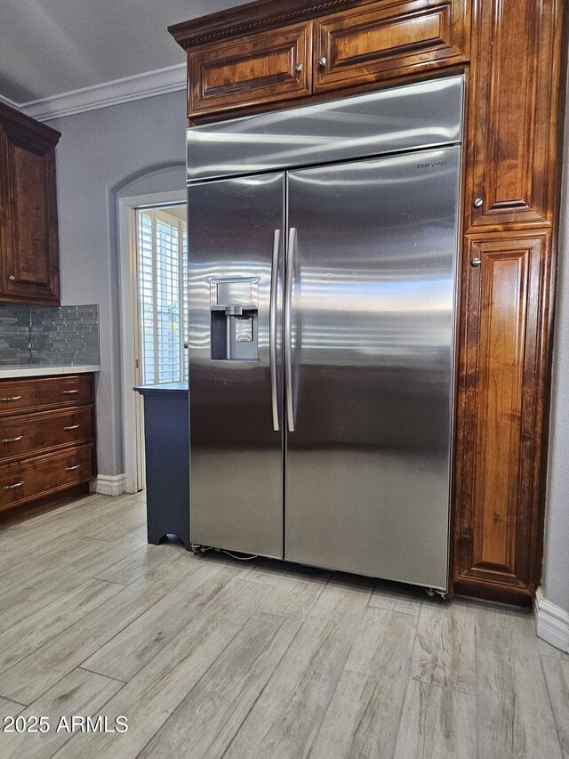 4530 W Misty Willow Ln, Glendale, AZ 85310 - kitchen featuring stainless steel built in refrigerator, backsplash, light hardwood / wood-style floors, and crown molding