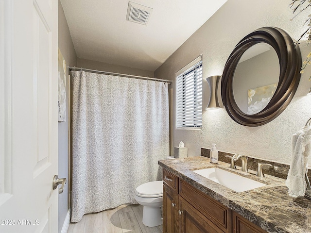 4530 W Misty Willow Ln, Glendale, AZ 85310 - bathroom with hardwood / wood-style flooring, vanity, and toilet