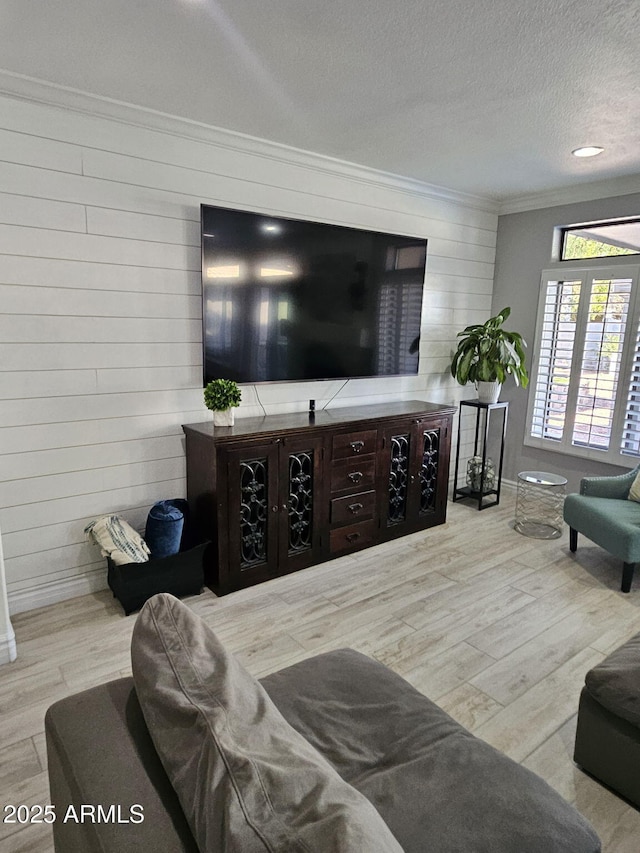 4530 W Misty Willow Ln, Glendale, AZ 85310 - living room with wooden walls, ornamental molding, a textured ceiling, and light wood-type flooring