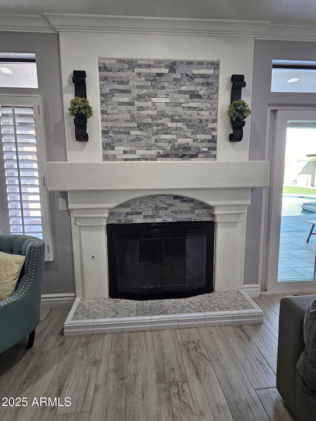 4530 W Misty Willow Ln, Glendale, AZ 85310 - details featuring a stone fireplace, hardwood / wood-style floors, and ornamental molding
