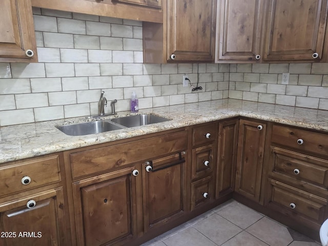 720 N 82nd St Unit E116, Scottsdale, AZ 85257 - kitchen with a sink, light tile patterned floors, tasteful backsplash, and light stone counters