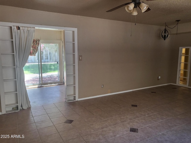 720 N 82nd St Unit E116, Scottsdale, AZ 85257 - spare room featuring dark tile patterned flooring, a ceiling fan, a textured ceiling, and baseboards