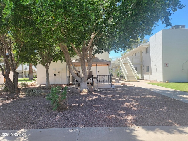 720 N 82nd St Unit E116, Scottsdale, AZ 85257 - view of front of house featuring stairs and a patio