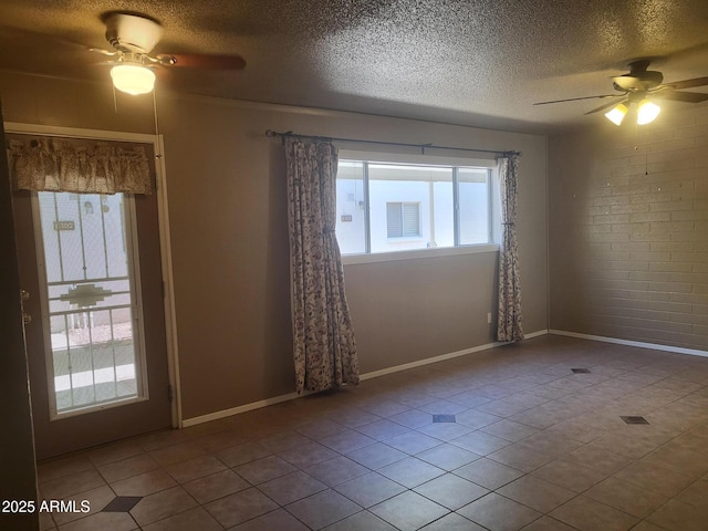 720 N 82nd St Unit E116, Scottsdale, AZ 85257 - empty room with ceiling fan, a textured ceiling, tile patterned floors, and baseboards
