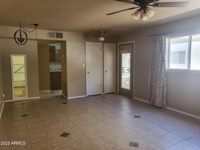 720 N 82nd St Unit E116, Scottsdale, AZ 85257 - spare room with a textured ceiling, light tile patterned floors, a ceiling fan, and baseboards