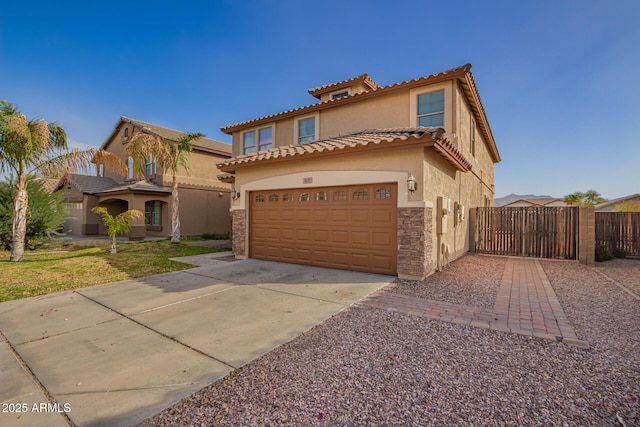 mediterranean / spanish-style house with driveway, a garage, a gate, fence, and stucco siding