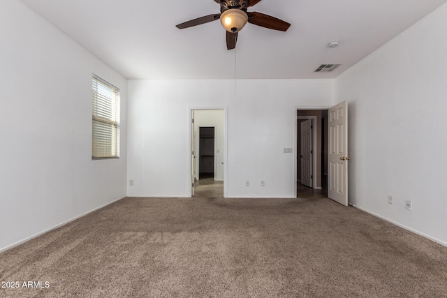 unfurnished bedroom featuring a ceiling fan, carpet, visible vents, and baseboards