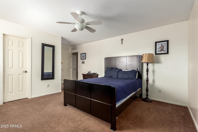 carpeted bedroom featuring a ceiling fan, visible vents, and baseboards