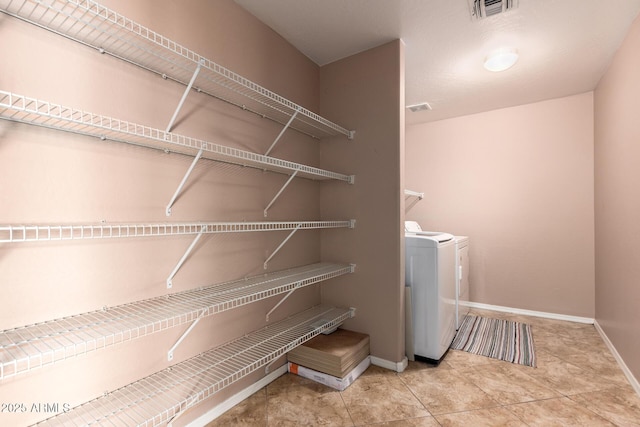 washroom with laundry area, washer / clothes dryer, visible vents, and baseboards