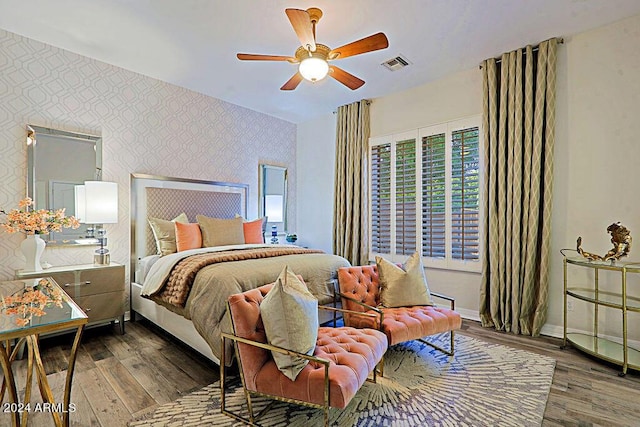 bedroom with ceiling fan and hardwood / wood-style flooring