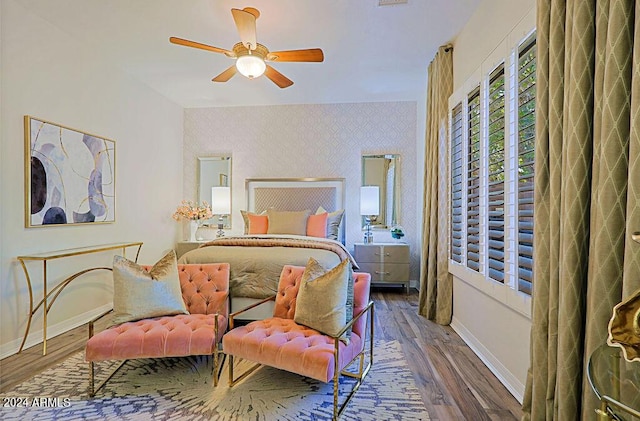 bedroom with dark hardwood / wood-style floors and ceiling fan