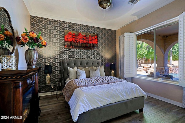 bedroom featuring ceiling fan, dark wood-type flooring, and crown molding