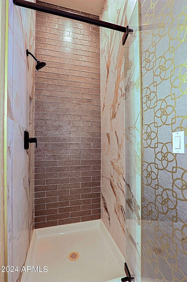 bathroom with tiled shower