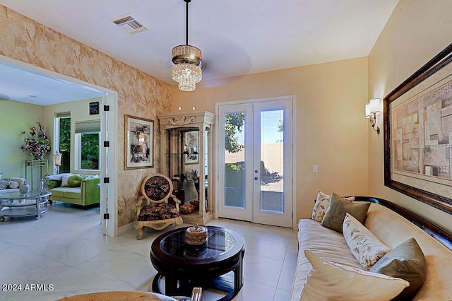 living room with a chandelier and french doors