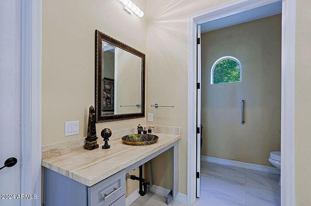 bathroom featuring toilet and vanity